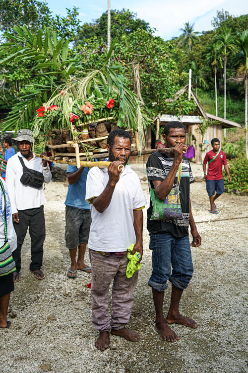 Four Saliba translators carrying in the replica house that contained the New Testament.